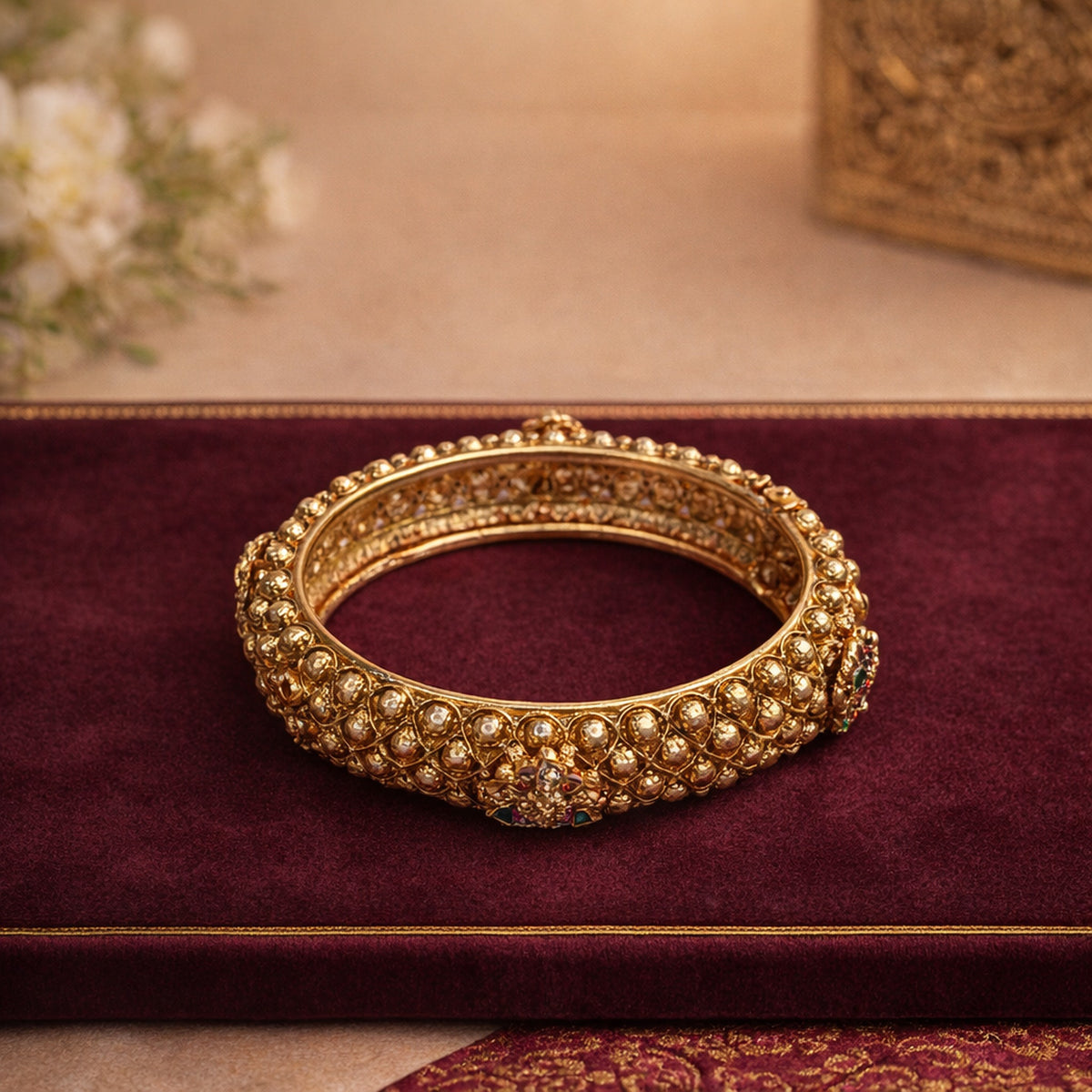 Antique gold beaded bangles on burgundy velvet