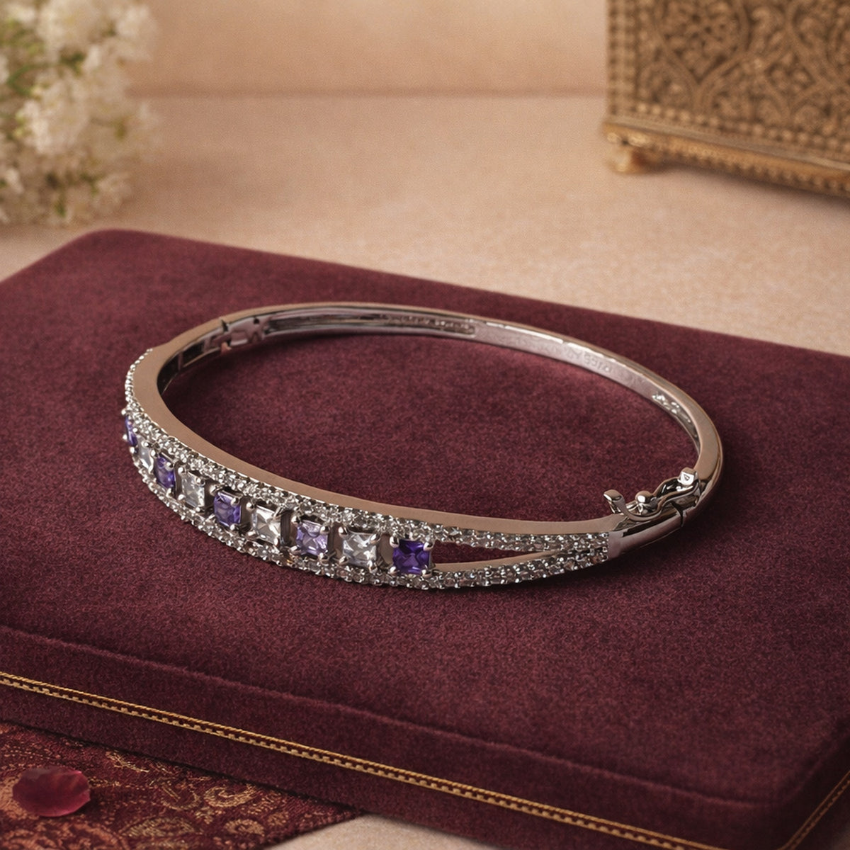 Silver-finish pavé bracelet with amethyst stones on burgundy velvet